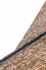 The edge of a tall building or a tower of red brick.