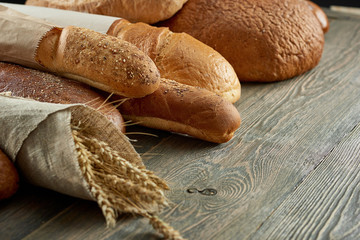 Top view studio shot of a heart shaped collection of different delicious freshly baked loafs of bread isolated on white food love nutrition healthy concept. 