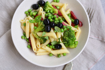 Pasta penne with salami and vegetables