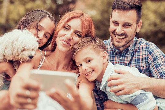 Family taking selfie with smart phone
