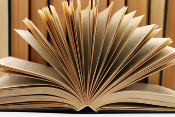 Opened old book against the background of other old books