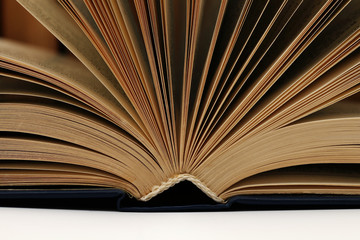 Opened old book against the background of other old books