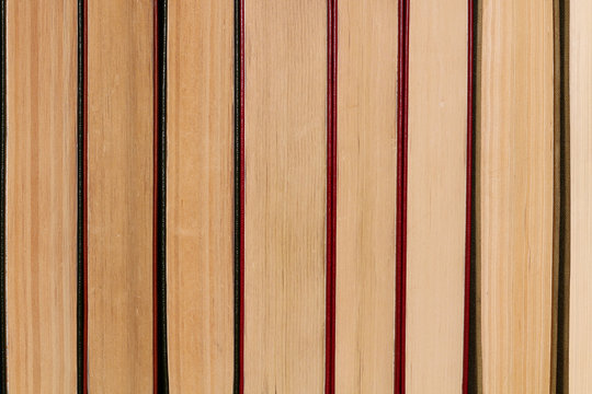 Horizontal row of old thick books close-up