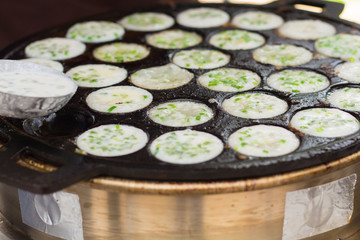 Thai dessert, Found to eat at rural areas. Made from coconut milk, and bake on pan with holes.