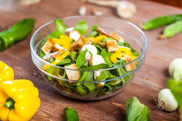 chicken salad bowl on kitchen table, balanced diet
