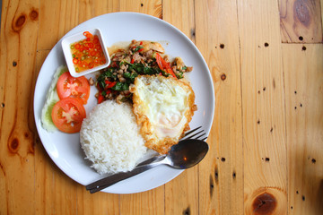 egg, pork fried rice, breakfast food on brown wooden background
