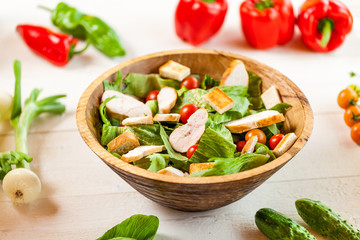chicken salad bowl on kitchen table, balanced diet