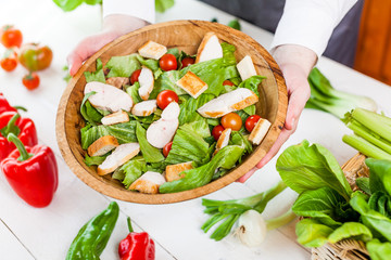 chicken salad bowl on kitchen table, balanced diet