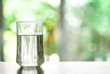 Close up purified fresh drink water from the bottle on table in living room