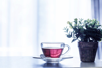 Close up the warm black tea cup on the wooden table in living room , relax with tea time concept
