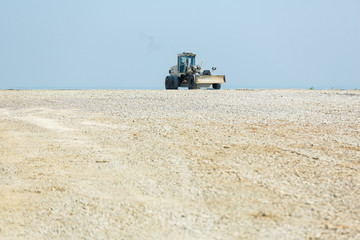 Grader tractor prepearing space for a construction