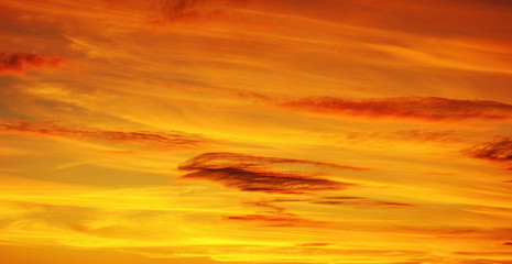 Photo of orange sunset with dark clouds on sky