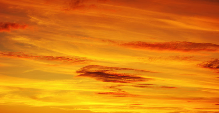 Fototapeta Photo of orange sunset with dark clouds on sky