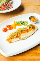 Grilled sea bass fish meat with sauce