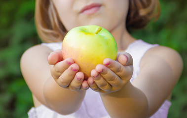 Child with an apple. Selective focus. 