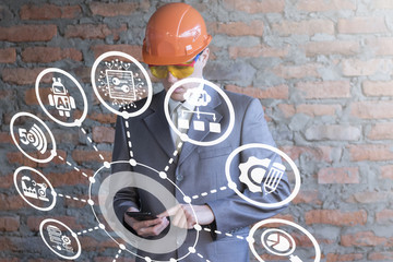 Smart Industry 4.0 Information Innovative Technologies concept. Industrial business man is controlled by the production process from a smartphone.