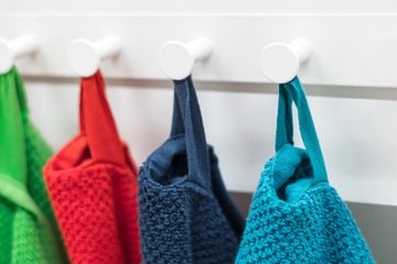 Colored towels hanging on the rack in the kitchen