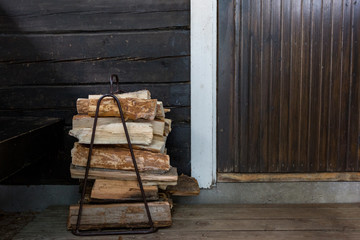 Firewood next to the open door to the traditional Finnish sauna