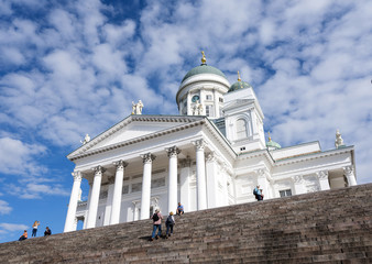 tourists on steps of helsinki cathedral on sunny summer day