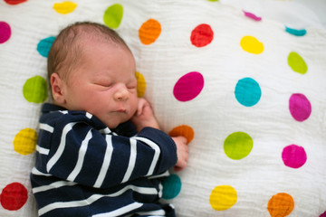 Fototapeta na wymiar Newborn baby laying in crib in prenatal hospital
