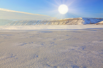 bright sun over frozen landscape