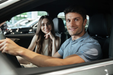 Couple sitting at the front seat of the car