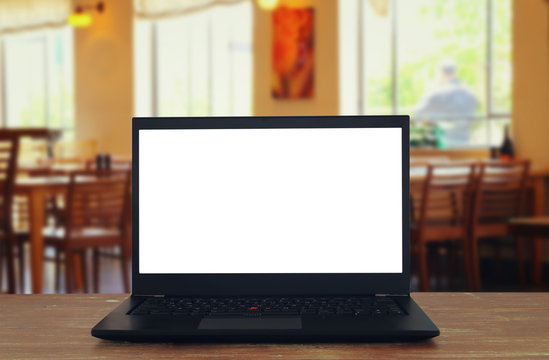 open laptop with white screen in front of abstract blurred restaurant lights background