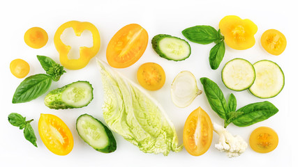 Set of slices of vegetables of yellow and green color isolated on white background top view, design for vegetable menu. Tomato onion cucumber sweet pepper zucchini Peking cabbage cauliflower basil.