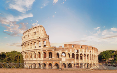 Fototapeta na wymiar Colosseum front view at pre-sunset time with marvelous sky.
