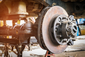 Old and rusty car's suspension, which removes the wheels for repair, replacement and change news parts -Automotive industry and garage concepts.