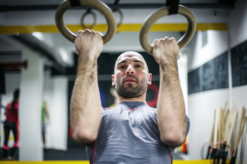 Attractive fit man working out at the gym. Fit and attractive man working out at a gym with dramatic lighting.