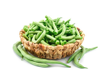 Fresh green beans in a basket on a white background.