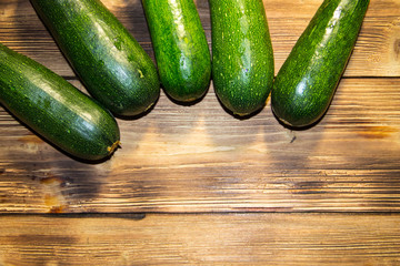 Fresh zucchini on wooden table. Top view