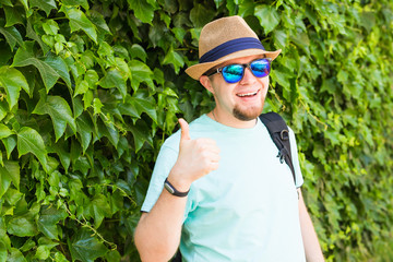 Young hipster man with thumb up