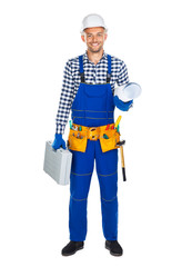 Full length portrait of happy construction worker in uniform with toolbox and drawings