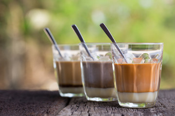 Hot drink thai milk tea, black coffee, cocoa signature local street beverage on wooden table