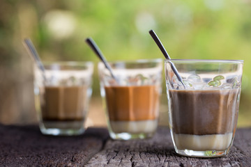 Hot drink thai milk tea, black coffee, cocoa signature local street beverage on wooden table