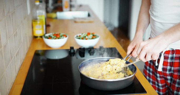 omelette with mushrooms in a frying pan on wooden table