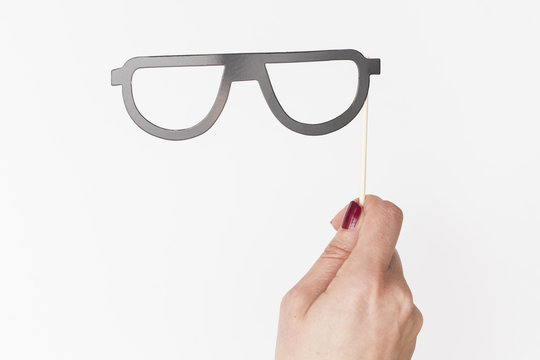 female hand holding glasses photo booth prop