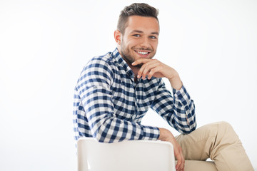 Portrait of handsome smiling man sitting on chair