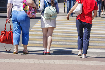 pedestrians women crossing a street in the city