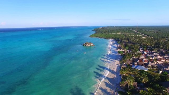 Aerial view of famous The Rock Restaurant situated on small island, surrounded by turquoise crystal clear water of blue lagoon, sunset time - Paje, Zanzibar, Tanzania, Africa, Indian Ocean, 4k UHD