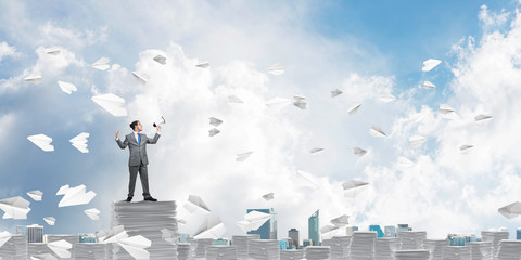 Businessman standing with megaphone.