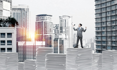 Businessman standing with megaphone.