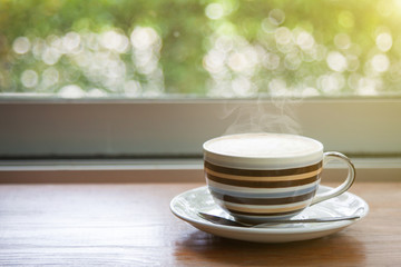 Coffee on a wooden table and a natural bokeh