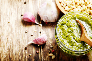 Top view of Pesto sauce and ingredients on wood table with copy-space