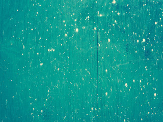 White Paint Spots on Green Plywood Construction Wall
