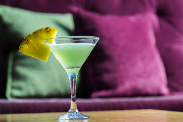 Coctail with pineapple in martini glass