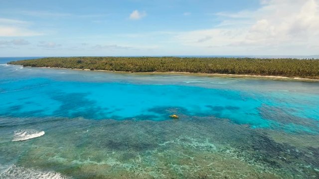 Aerial view of beautiful tropical island Daco with white sand beach. View of a nice tropical beach from the air. Beautiful sky, sea, resort. Seascape: Ocean and beautiful beach paradise. Philippines