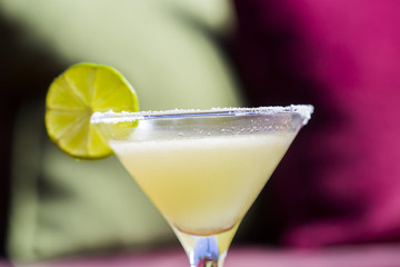 Yellow coctail with lime, margarita cocktail with salty rim